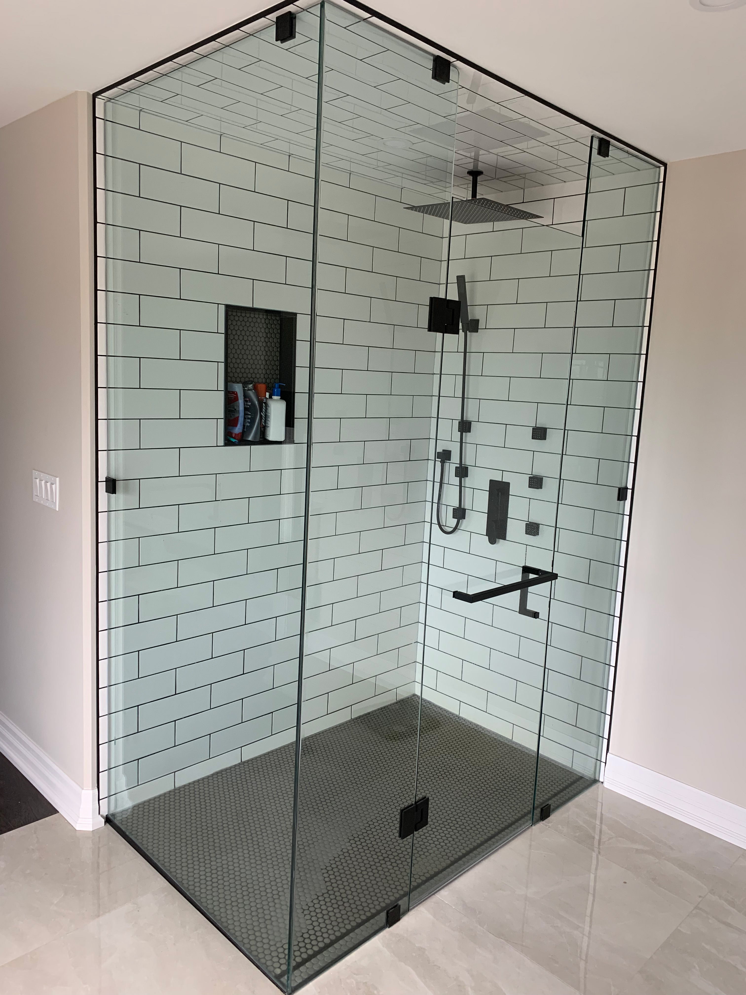 Green subway tile shower with black hardware