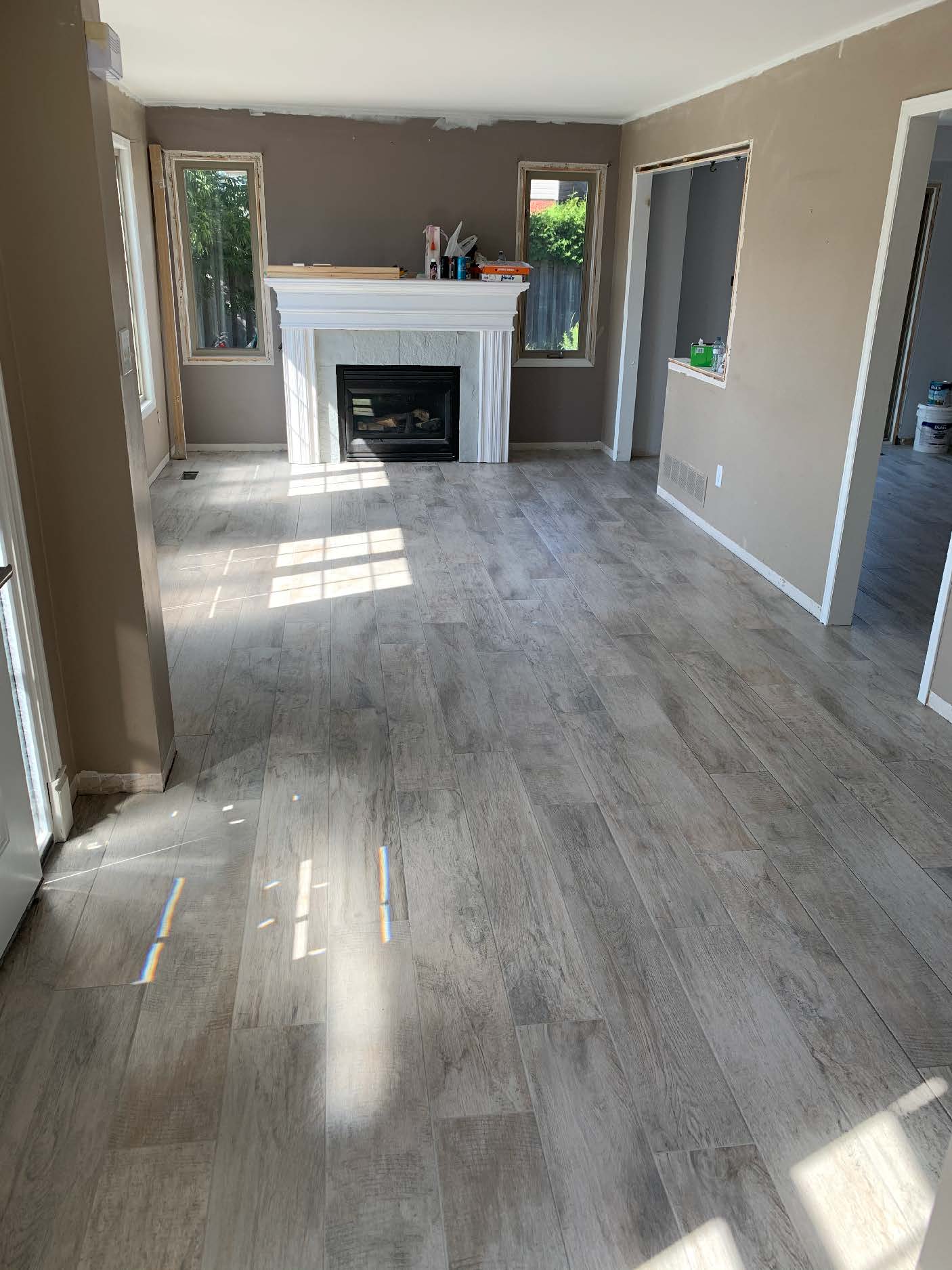 Gray wood-look tile flooring with fireplace