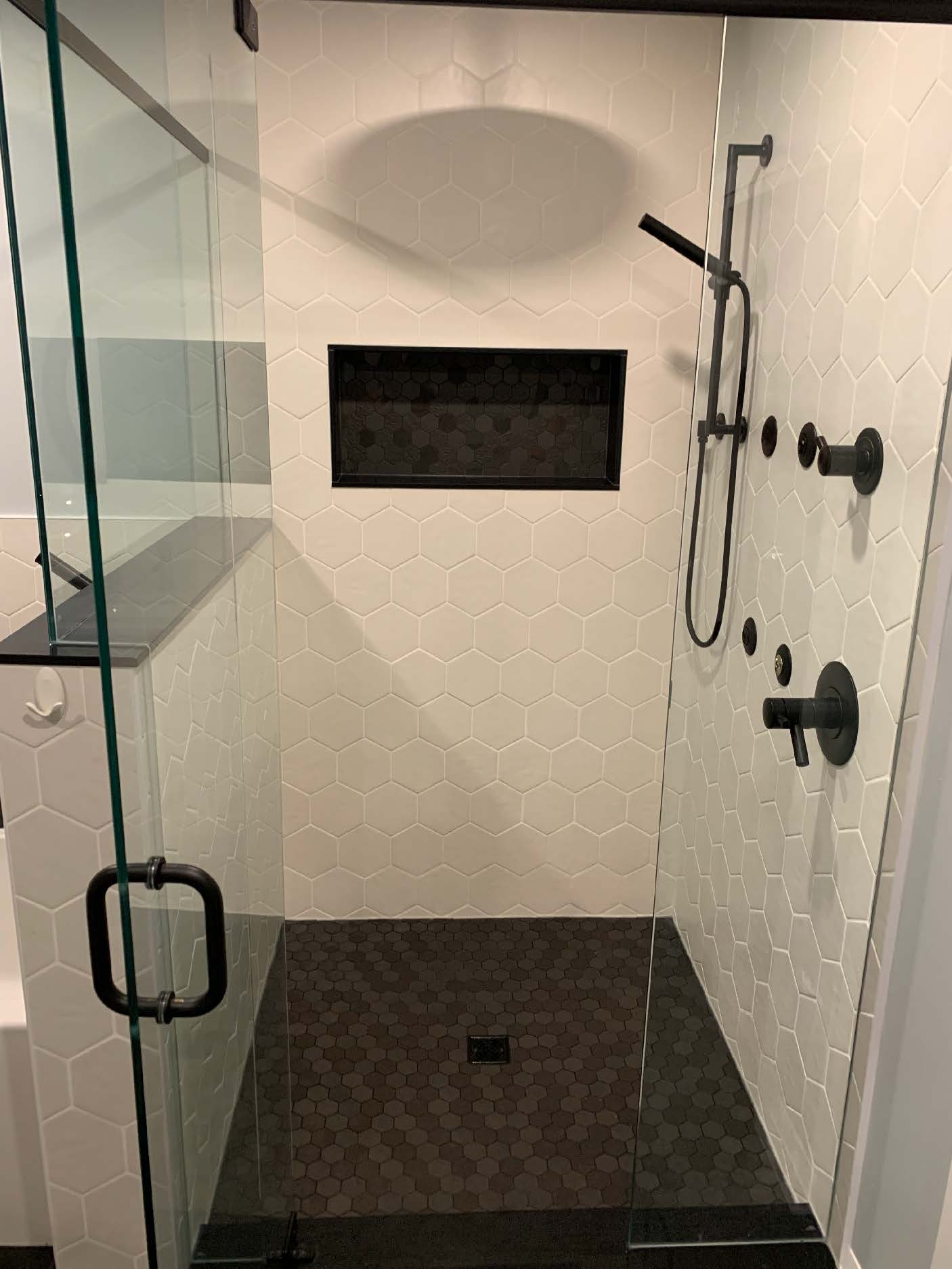 Hexagonal tile shower with black fixtures